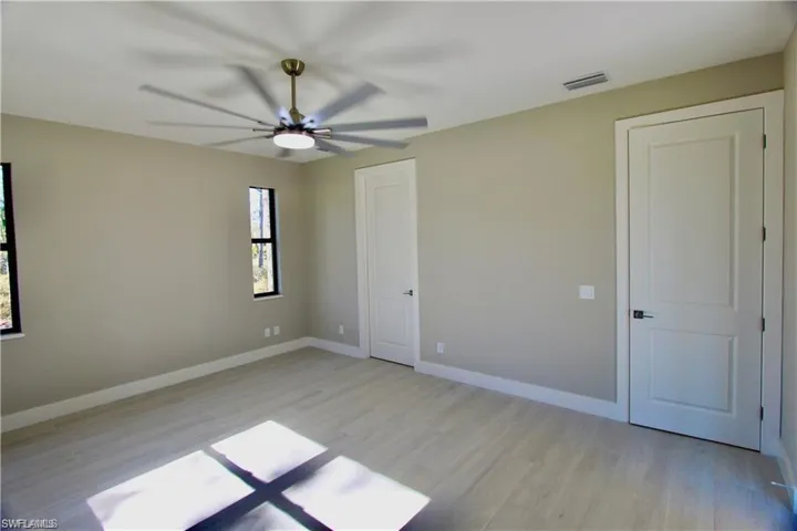 Empty room featuring ceiling fan and light hardwood / wood-style flooring