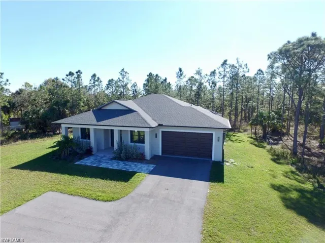 View of front of home featuring a garage and a front yard
