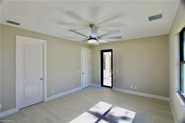 Unfurnished room with light wood-type flooring and ceiling fan