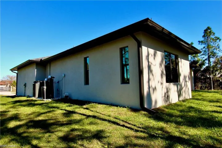 View of property exterior with a yard