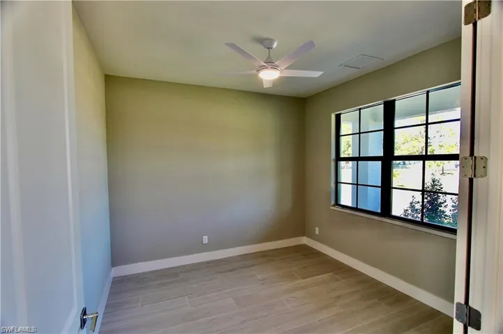 Empty room featuring ceiling fan and light wood-type flooring
