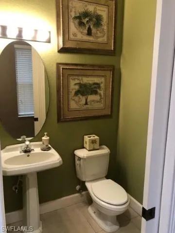 Bathroom featuring tile patterned floors and toilet