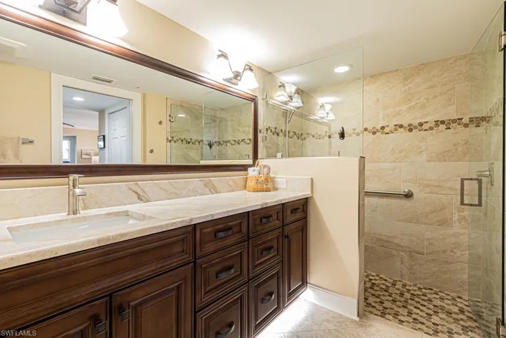 Master bathroom with large tile shower and toe mold lighting.