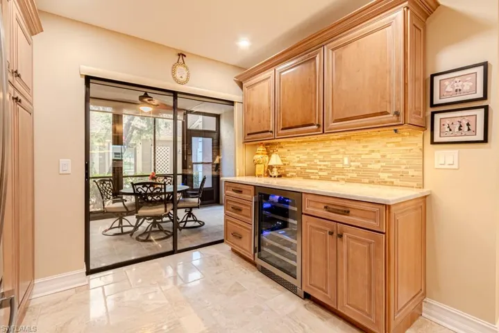 Kitchen bar with undercounter wine refrigerator.