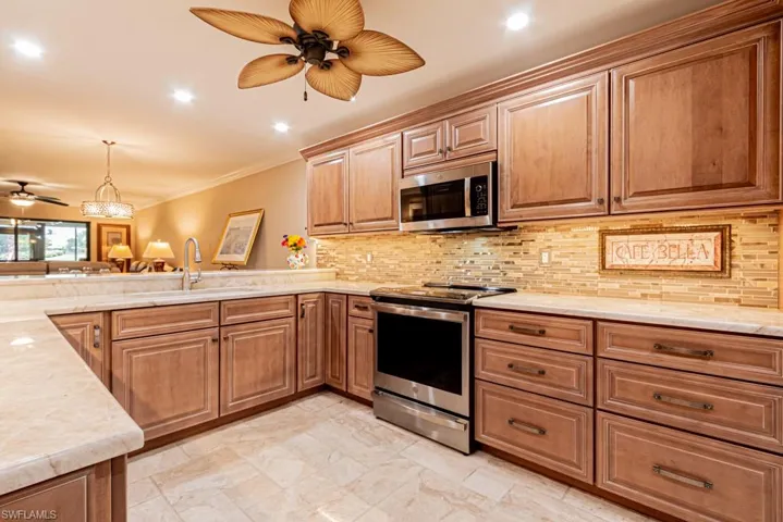 Kitchen with high end GE Profile stainless steel appliances (Induction range, refrigerator, silent dishwasher, microwave, disposal, and undercounter wine refrigerator).