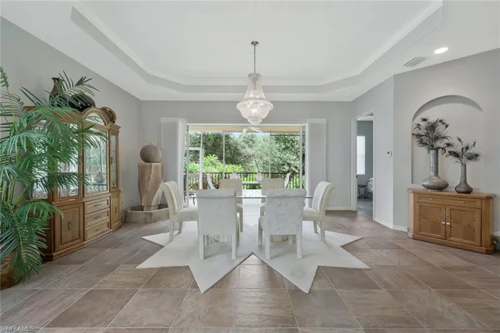 Dining Area with Tray Ceiling Detail and Lovely Chandelier