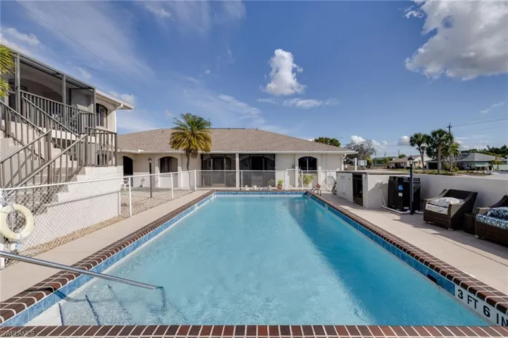 Community pool with stairway and a patio