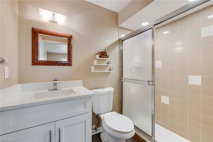 Bathroom featuring a shower stall and vanity