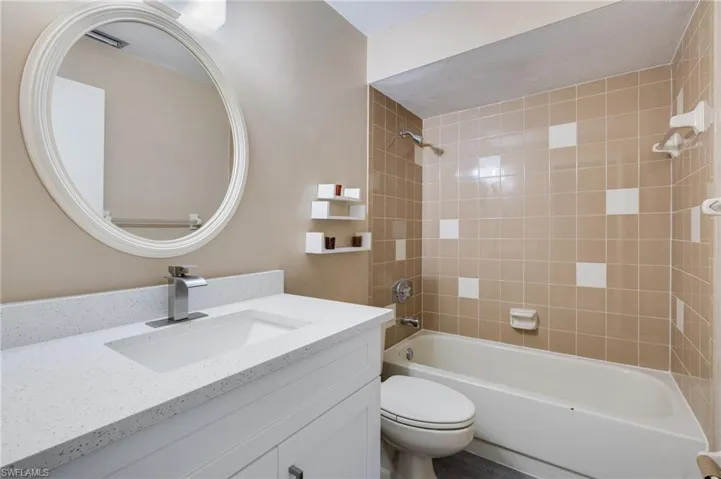 Bathroom featuring washtub / shower combination and vanity