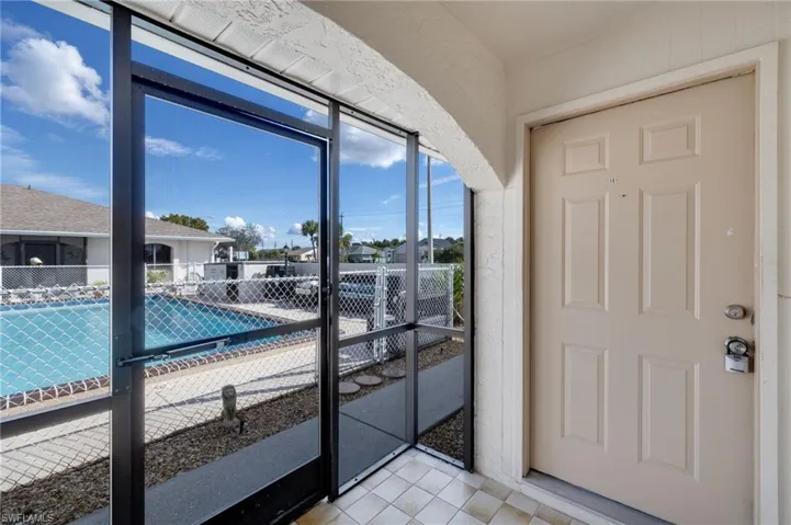 Doorway to outside featuring tile patterned flooring and a residential view
