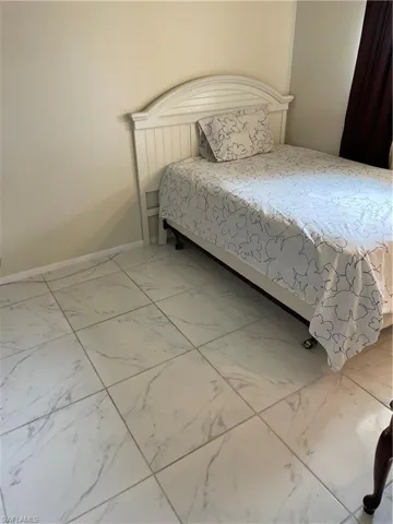 Bedroom featuring tile floors