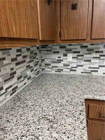 Interior details featuring light stone counters and backsplash