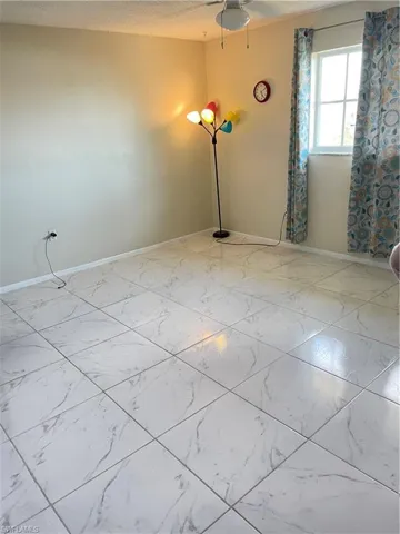 Spare room featuring a textured ceiling and tile floors