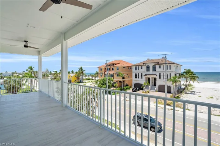 Wooden terrace with a water view and ceiling fan