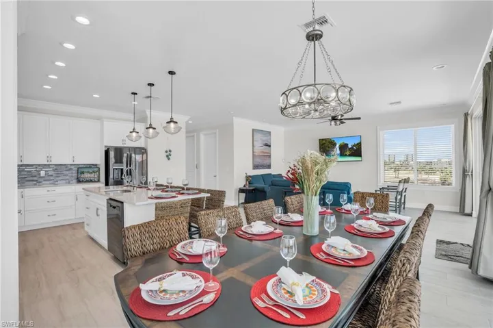 Dining space with sink, crown molding, with LVP wood-style flooring