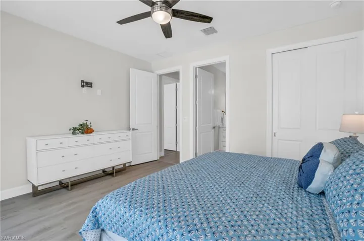 Bedroom with a closet, hardwood / wood-style flooring, and ceiling fan