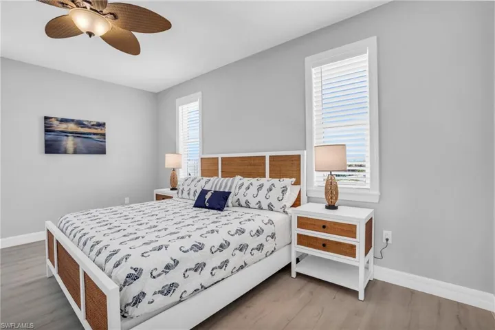 Bedroom with hardwood / wood-style floors and ceiling fan