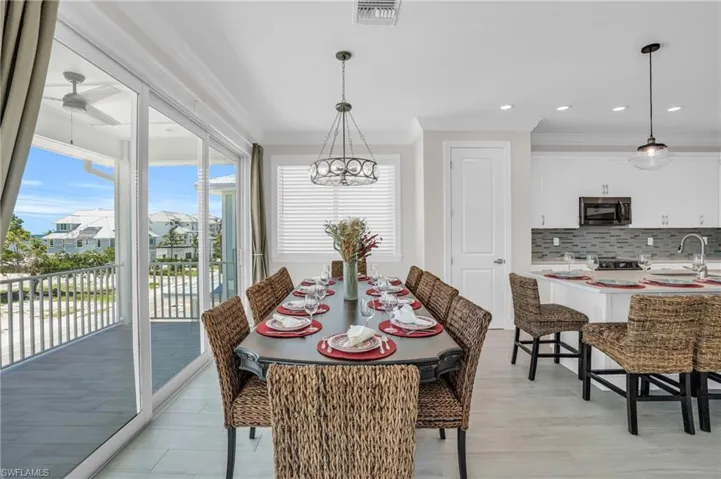 Dining room featuring an inviting chandelier, sink, and ornamental molding