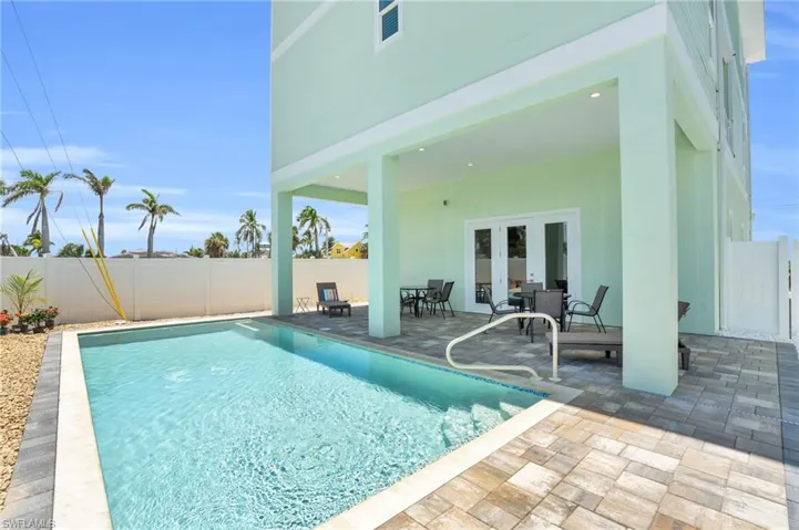 View of pool featuring a patio area and french doors