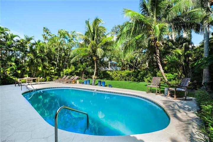 beautiful pool with privacy and a dead end cul de sac behind the home with a giant oak tree.