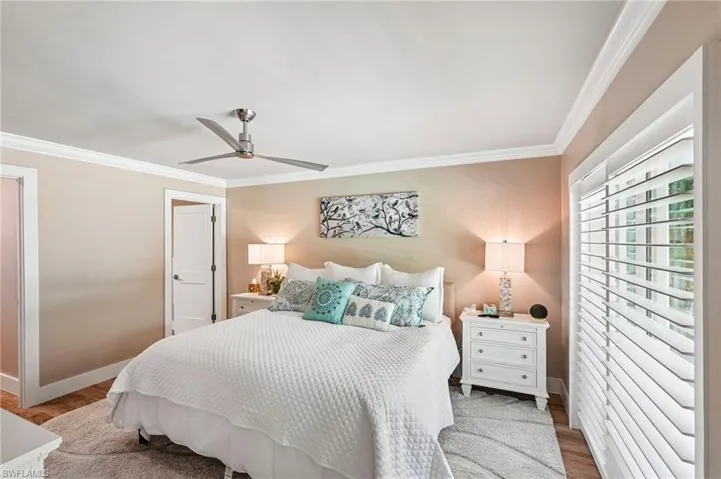 Crown molding and wood-finish flooring complement the room