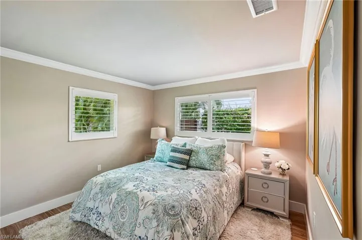 Crown molding, wood-finish flooring, and window shutters