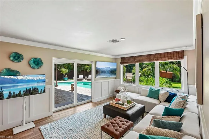 Wood-finish flooring with white wainscoting and crown molding