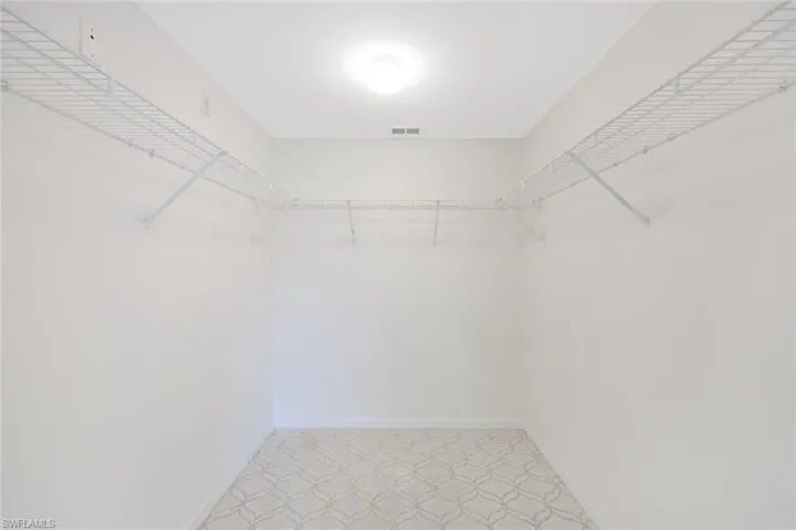 Primary suite offers a spacious walk-in closet.