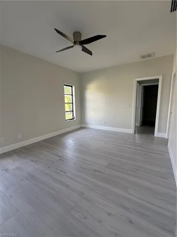 Empty room featuring light wood-type flooring and ceiling fan