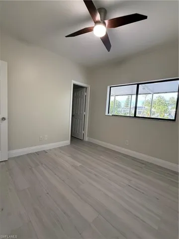 Spare room with a ceiling fan and light wood-style flooring