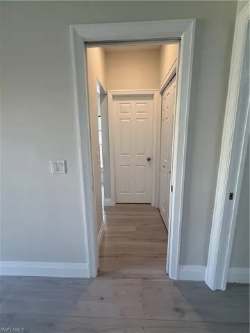 Hall featuring baseboards and light wood-style floors