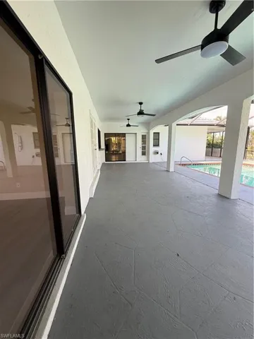 View of patio / terrace with ceiling fan and an outdoor pool