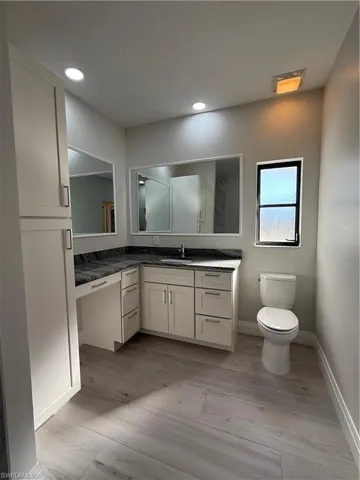 Bathroom featuring vanity, recessed lighting, and light wood finished floors