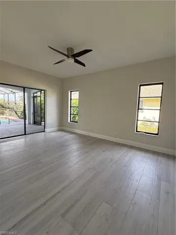 Spare room with light wood-style flooring and ceiling fan
