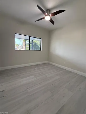 Spare room with light wood-style flooring and a ceiling fan