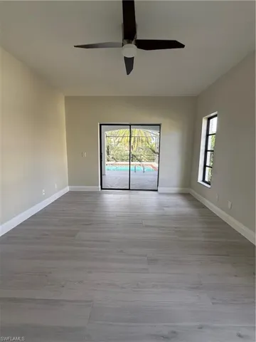 Unfurnished room featuring light wood finished floors and ceiling fan