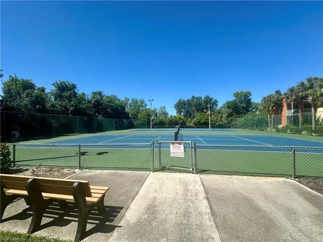 tennis court with a gate and fence