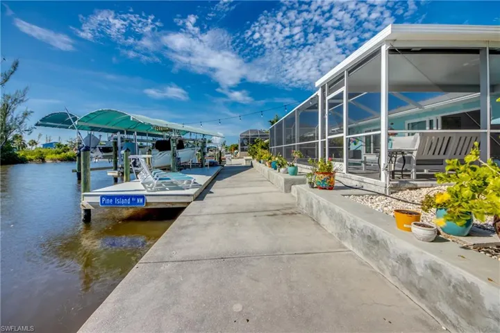 View of dock featuring a lanai and a water view