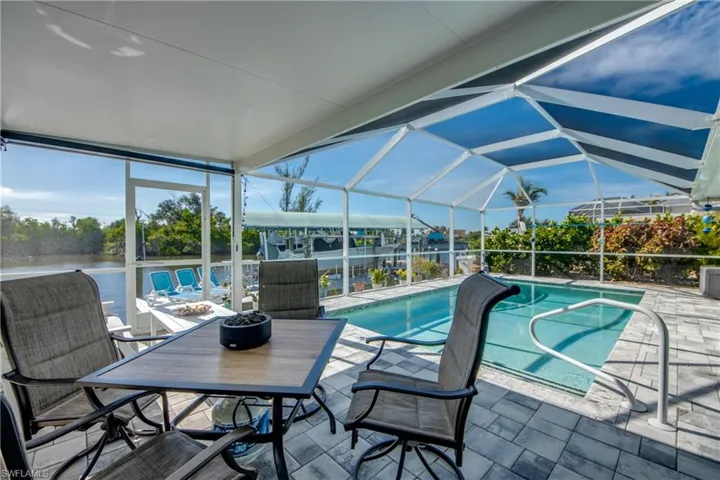 View of swimming pool with a water view  view, a patio area,
