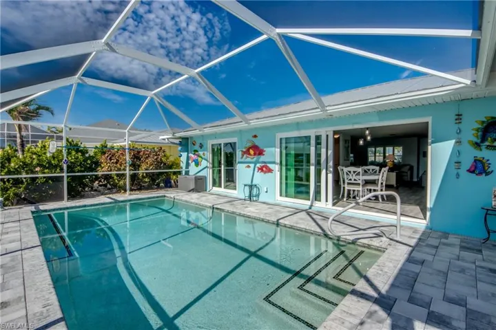View of swimming pool featuring a lanai and a patio area