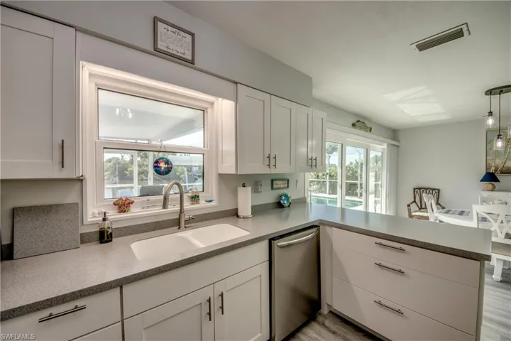 Kitchen featuring dishwasher, a healthy amount of sunlight, and light hardwood / wood-style floors