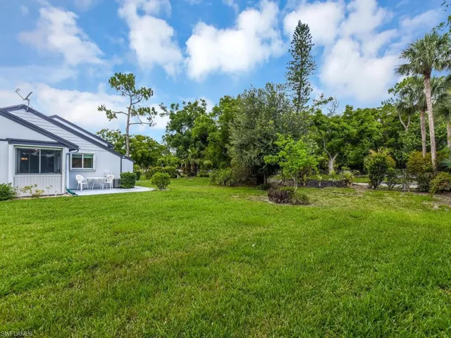 View of green lawn featuring a patio