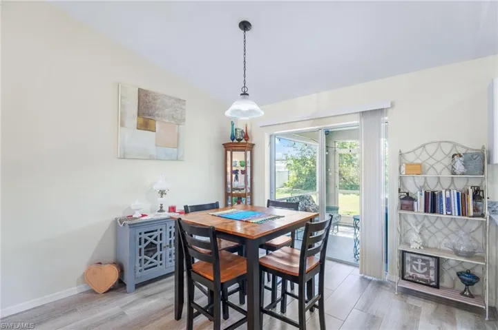 Dining area featuring wood-type flooring and lofted ceiling