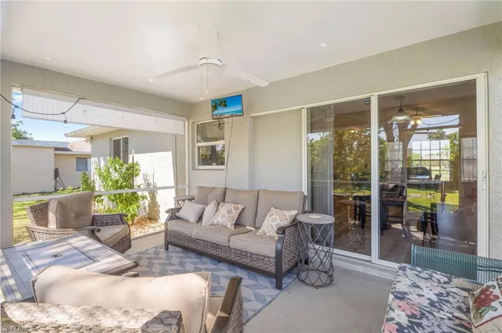 Sunroom featuring ceiling fan and plenty of natural light