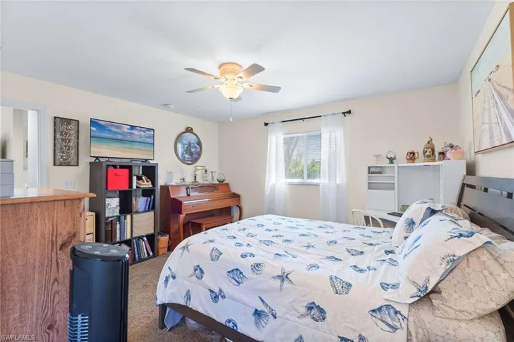 Carpeted bedroom with ceiling fan