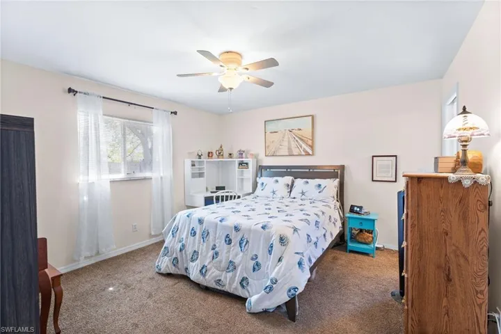 Carpeted bedroom with ceiling fan
