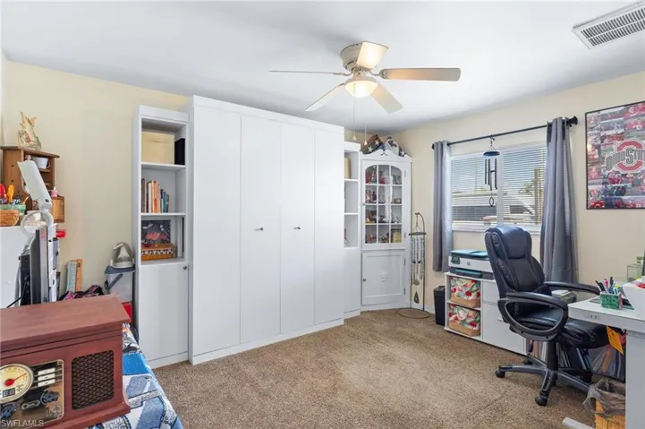 Office space featuring light carpet and ceiling fan