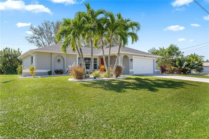 Ranch-style house with a garage and a front yard