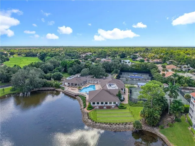 Aerial view of a pool area and a large body of water