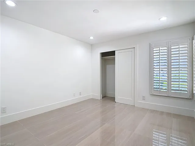 Unfurnished bedroom featuring recessed lighting and a closet